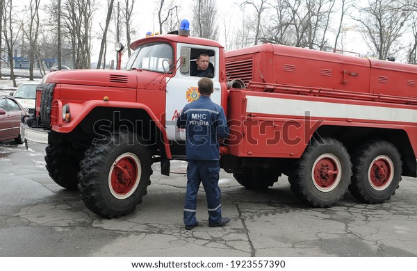 An employee\
of the Ministry of Emergency Situations of Ukraine near a fire\
truck in Kiev, on Monday, April 1,\
2013.