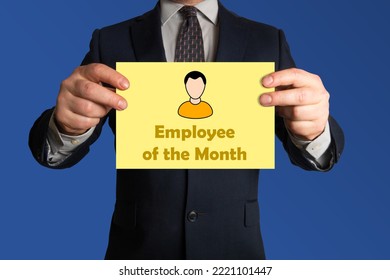 Employee of the month award or prize. Businessman with a sheet of paper stating employee of the month. - Shutterstock ID 2221101447