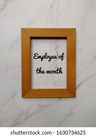 Employee Of The Month. Word Written In A Frame On Marble Wall