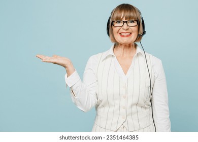 Employee operator business woman in set microphone headset for helpline assistance wear white classic suit glasses formal clothes working at call center isolated on plain pastel light blue background - Powered by Shutterstock