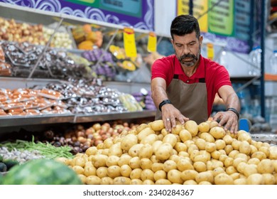 Employee organizes products in supermarket - Powered by Shutterstock