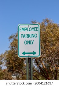 An Employee Parking Only sign with a bidirectional arrow below. - Shutterstock ID 2004121637
