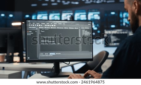 IT employee programming in server hub housing supercomputers storing datasets. Close up shot of expert typing code on computer to mend data center racks doing complex computational operations