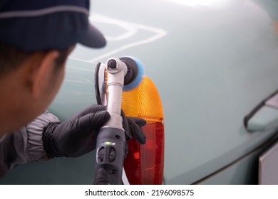 The Employee Of The Shop Paint The Body Of The Car, Sanding The Painted Part Of A Pneumatic Tool