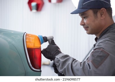 The Employee Of The Shop Paint The Body Of The Car, Sanding The Painted Part Of A Pneumatic Tool