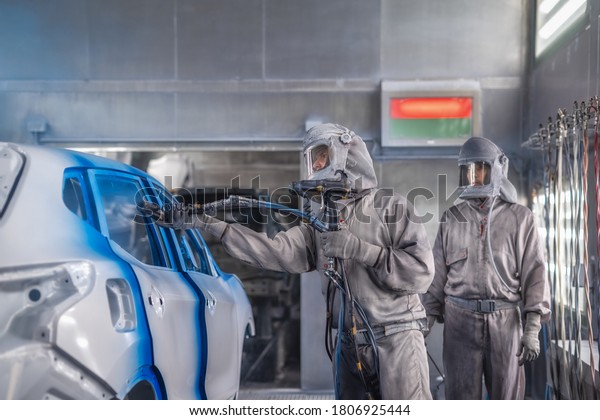 employee shop painting the\
car body produces painting elements of the interior of the car\
close-up.