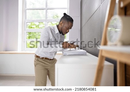 Employee Stealing Documents In Office Using Phone. Secret Theft