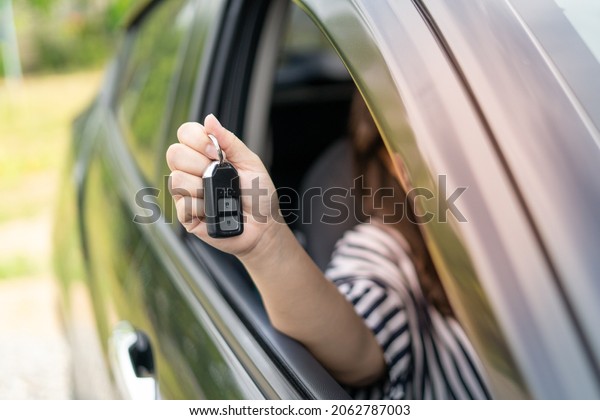 An employee of a tourist car rental company\
presents the car keys with a test drive. Good service before\
agreeing to a lease or purchase\
contract.