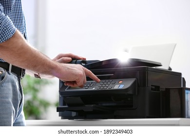 Employee using modern printer in office, closeup