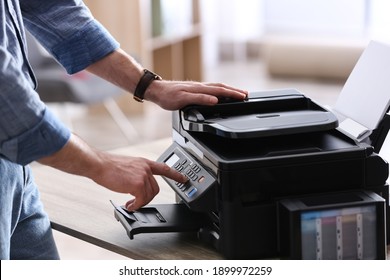Employee using modern printer in office, closeup