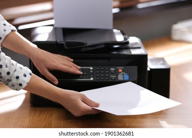 Employee using modern printer in office, closeup