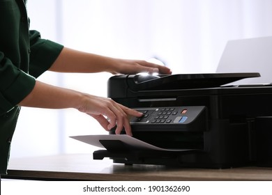 Employee using modern printer in office, closeup