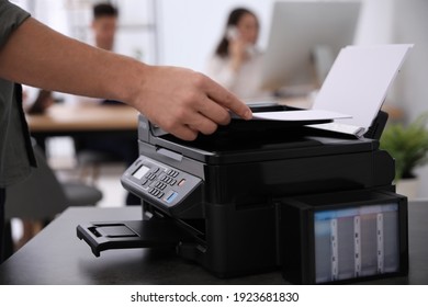 Employee using modern printer in office, closeup