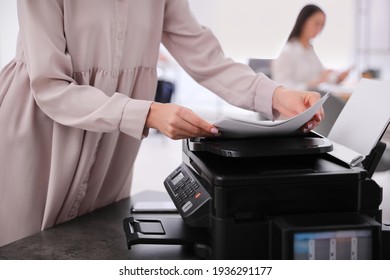 Employee using modern printer in office, closeup