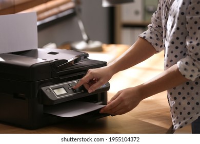 Employee using modern printer in office, closeup