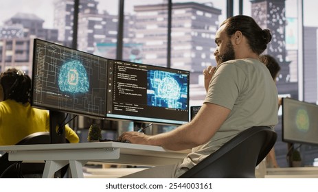 Employee utilizing AI resources and platforms to train and deploy machine learning models, handheld camera shot. Man monitoring and maintaining artificial intelligence company systems, camera A