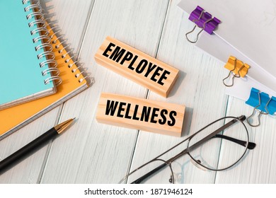 Employee Wellness - Words Written On Wooden Blocks Near Office Supplies