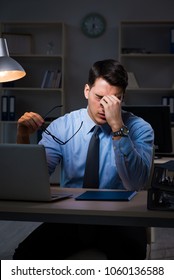 Employee Working Late At Night At Important Report