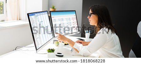 Employee Working On Calendar Schedule And Staff Time Sheet