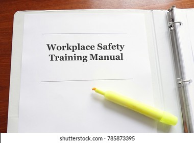 Employee Workplace Safety Training Manual On A Desk With Highlighter                               