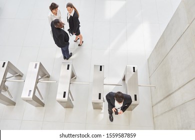 Employees at the check-in as access control for better security in the Group - Powered by Shutterstock