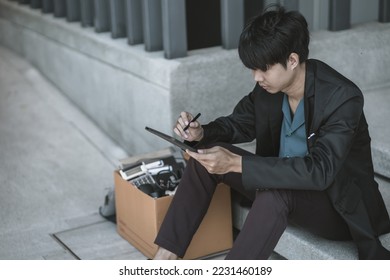 Employees fired or resigned from the company are using tablet to find a jobs.Unemployed, hiring job, quitting job concept. - Shutterstock ID 2231460189