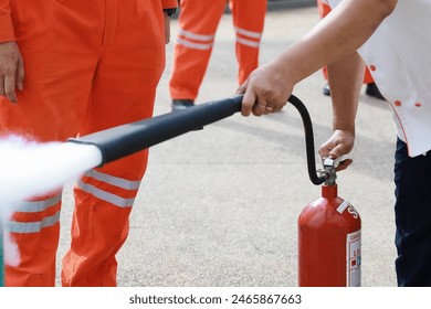 Employees firefighting training, Concept Employees hand using fire extinguisher fighting fire closeup. Spray fire extinguisher.	
 - Powered by Shutterstock