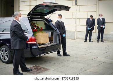 Employees Of The Funeral Services Company Next To The Coffin Of A COVID-19 Victim, In Turin, Italy, April 2020.