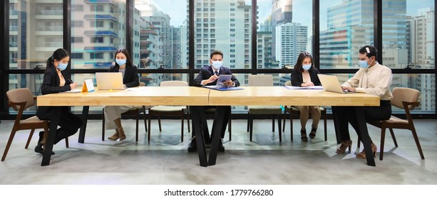 Employees With Mix Sex Including LGBT Working Together In Co-working Space Following Social Distancing And New Normal Policy By Wearing Facial Mask In The Business Office Workplace During Covid-19