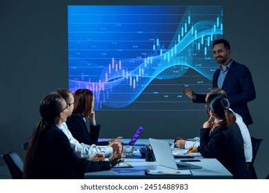 Employees in office setting analyze digital stock chart displayed on digital wall during meeting in boardroom. Economic trends. Concept of business, entrepreneurship, trade market, economics, finances - Powered by Shutterstock