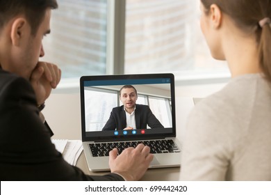 Employees Participate Virtual Conference With Boss Running Business Remotely, Businesspeople Hold Online Meeting On Laptop Group Chat, Entrepreneurs Making Video Call To Partner, Close Up Rear View