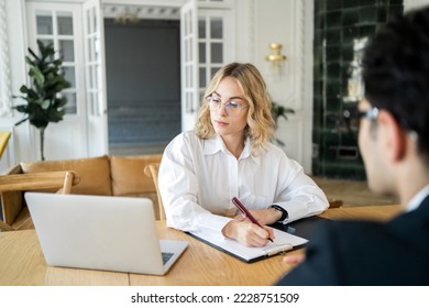 Employees people in the office are working on a new startup and project. Financiers are a man and a woman in business suits. - Shutterstock ID 2228751509
