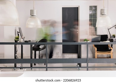 Employees silhouettes walking in motion in unicorn business coworking space, long exposure effect. Blurred company workers, startup office staff workday, work rush creative concept, wide shot - Shutterstock ID 2206826923