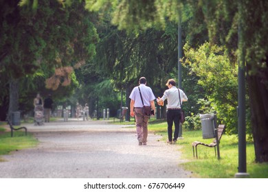 employees trust and friendship, back view of two businessmen at the park (image with copy space)
