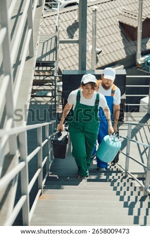 Employees walking up external steps with tools and equipment. Concept of service crew arrival, apartment maintenance workflow, HVAC installation appointment, professional house calls.