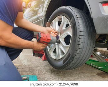 Employees wheel repairing car outdoor service without glove, unsafety concept to reduce accidents.
