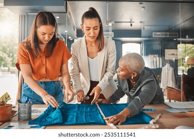 Employees, women and cutting fabric as fashion designer at office with patterns or clothes on project . Startup, partnership and creative director with teamwork, collaboration or coworking as stylist - Powered by Shutterstock