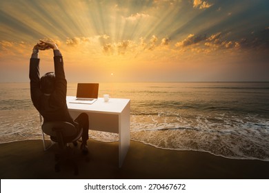 Employees work during rest and relaxation Imagine him sitting in the office. At the beach in the morning. - Powered by Shutterstock