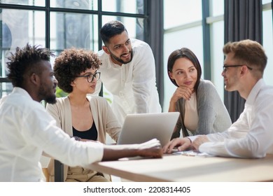 Employees working at computer together, discussing content - Shutterstock ID 2208314405