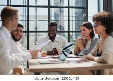 Employees working at computer together, discussing content - Shutterstock ID 2208314413