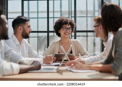Employees working at computer together, discussing content - Shutterstock ID 2208314419