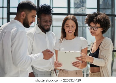 Employees working at computer together, discussing content - Shutterstock ID 2208314429