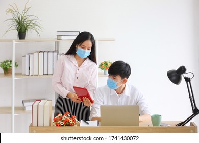 Employees Working From Home Office While Wearing Medical Face Mask For Social Distancing In New Normal Situation For Protecting And Preventing The Infection Of Corona Virus Or Covid-19