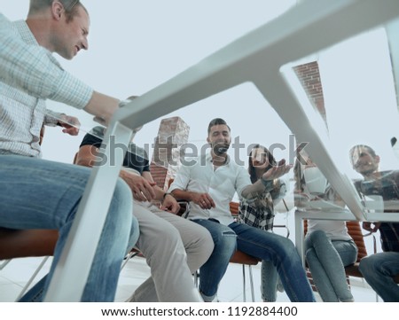 Similar – Multiethnic friends resting outside food truck in evening