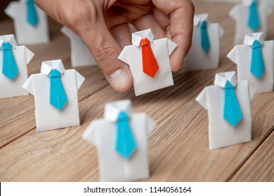 Employer chooses takes in hand employee. Leader stands out from crowd. Looking for good worker. HR, HRM, HRD concepts - Shutterstock ID 1144056164