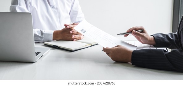 Employer or committee holding reading a resume with talking during about his profile of candidate, employer in suit is conducting a job interview, manager resource employment and recruitment concept. - Powered by Shutterstock