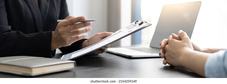 Employer or HR department is reading the resume and interviewing the ability of new employees, Employer is selecting job applicants, Employment and Recruitment Concept. - Shutterstock ID 2154259149