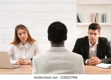 Employers Conducting Job Interview With African American Man In Office. Racism Concept