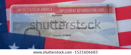 Employment Authorization card on USA Flag surface. Close up view. Wide photo