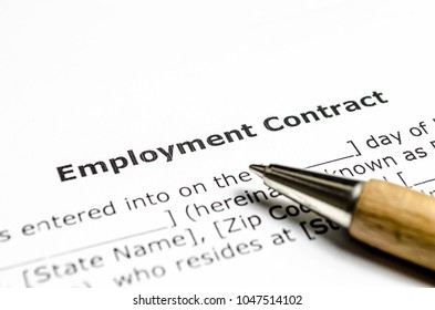 Employment contract with wooden pen - Shutterstock ID 1047514102